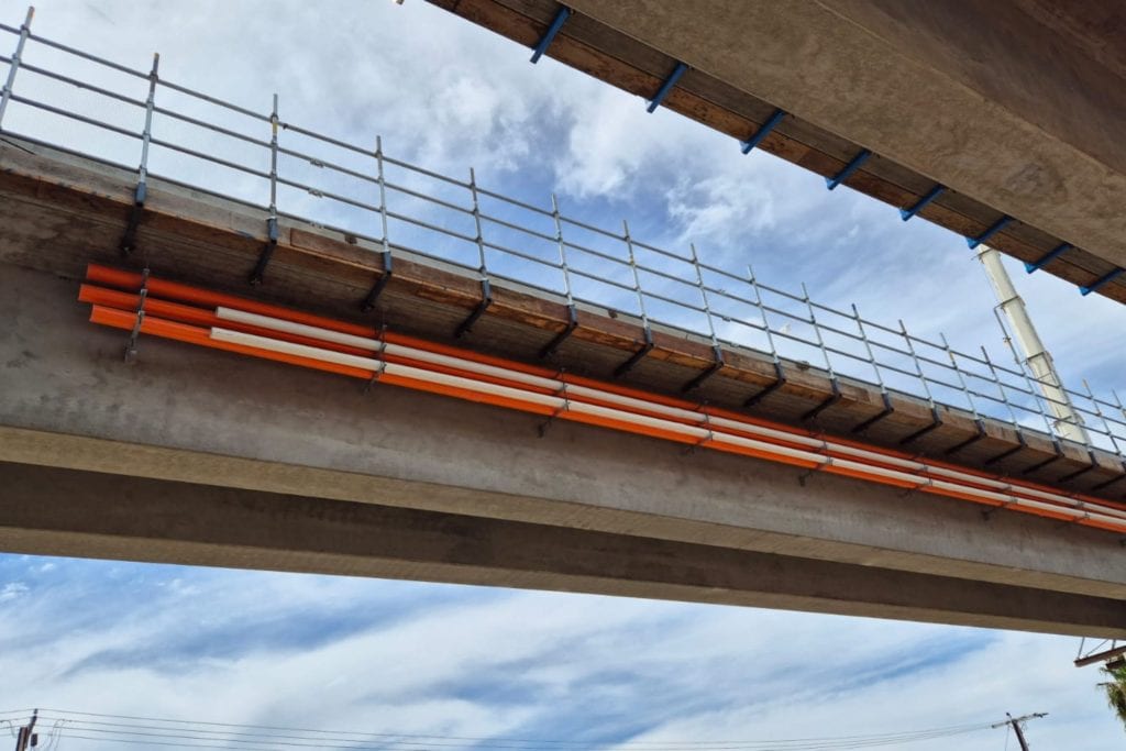 Tram Grade Separation Project electrical conduit installation Apex Energy Australia electrical and communications conduits installed beneath a tram overpass for the Tram Grade Separation Project.